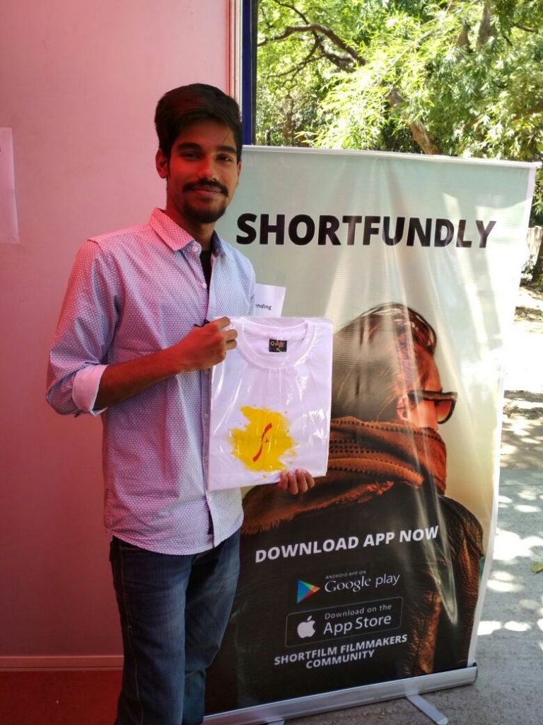 A man holding Shortfundly T-shirt - Movie Buff Subscription 